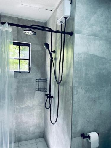 a shower in a bathroom with a shower curtain at Kenepa Apartments in Willemstad