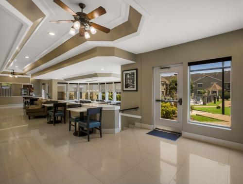 a living room with a ceiling fan and a dining room at Sleep Inn Savannah Midtown in Savannah