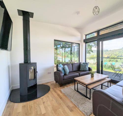 a living room with a couch and a wood stove at Lodge 16 Aberfeldy in Aberfeldy