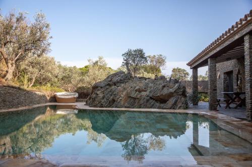 a swimming pool in front of a house at Es Cloper in Cadaqués