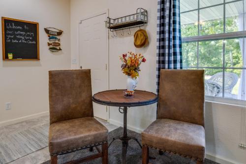 a table with two chairs and a vase of flowers at Charming Gravois Mills Escape with Private Backyard! in Gravois Mills