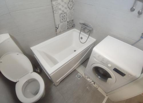 a small bathroom with a toilet and a sink at Apartman Kvart in Sarajevo