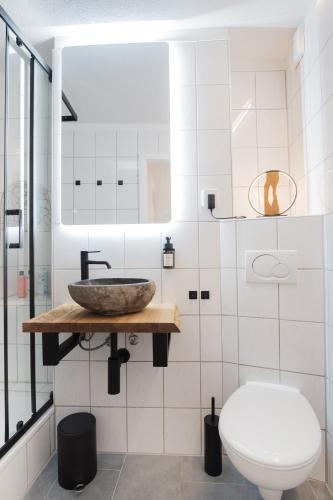 a bathroom with a sink and a toilet at NEU / Design / Altstadt / Küche / NETFLIX in Bad Säckingen