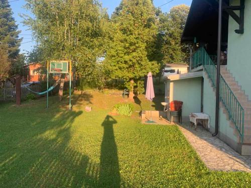 Ein Schatten einer Person, die Basketball auf einem Hof spielt in der Unterkunft Vila Dalmatinka in Gornja Toplica