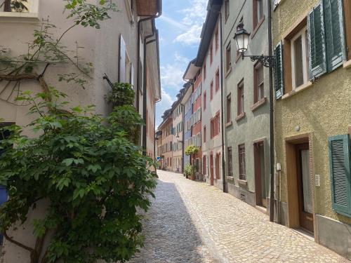 an empty street in an alley with buildings at NEU / Design / Altstadt / Küche / NETFLIX in Bad Säckingen