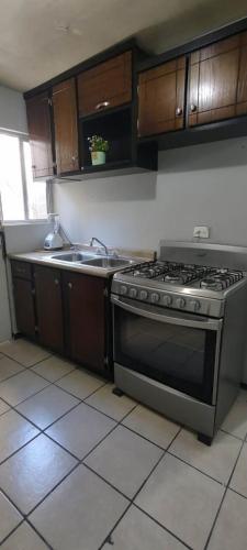 a kitchen with a stove and a sink at Depa M&J Cd. Juarez in Ciudad Juárez