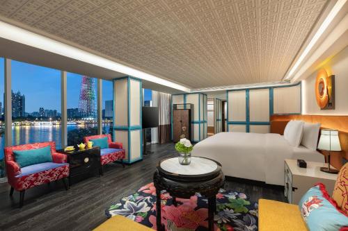 a hotel room with a bed and a large window at Hotel Indigo Guangzhou Haixinsha by IHG - Free Shuttle Bus to Canton Fair Complex during Canton Fair period in Guangzhou