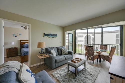 a living room with a couch and a table at Waterfront Marco Island Condo with Pool and Hot Tub! in Marco Island