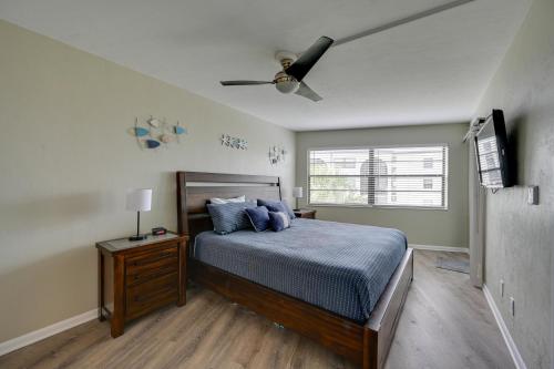 a bedroom with a bed and a ceiling fan at Waterfront Marco Island Condo with Pool and Hot Tub! in Marco Island