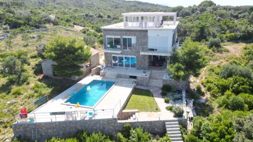 an aerial view of a house with a swimming pool at Sunset Villa Montenegro in Radovanići