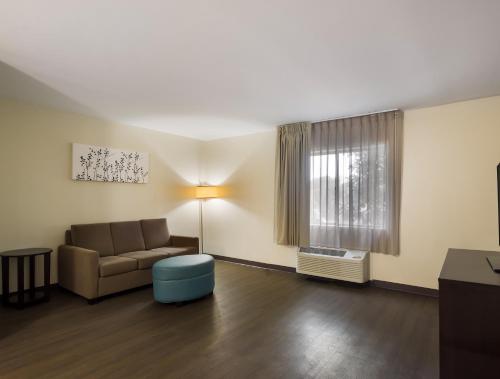 a living room with a couch and a window at Sleep Inn Savannah Midtown in Savannah