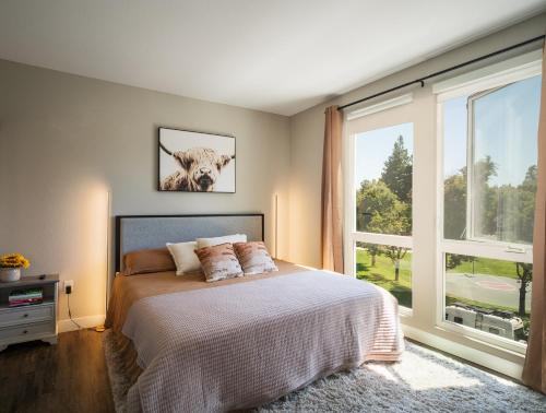 a bedroom with a bed and a large window at KING BED Modern 2 Bed 2 Bath Pool & Hot Tub in Mountain View