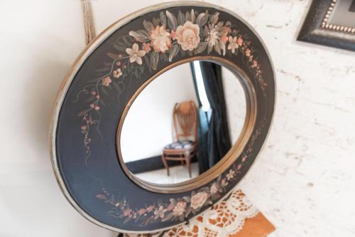 a mirror with a floral design on a wall at Beard and Lady Inn in Chester