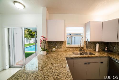 a kitchen with a sink and a counter top at Calle 8 Marvel - Miami Oasis Retreat L55 in Miami