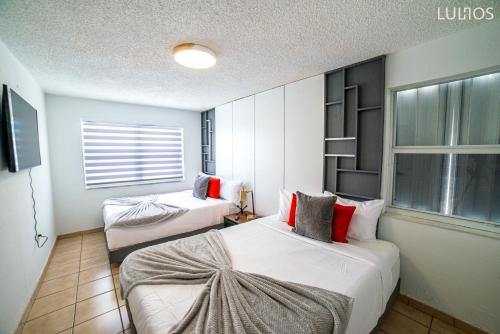 a hotel room with two beds and a window at Calle 8 Marvel - Miami Oasis Retreat L55 in Miami