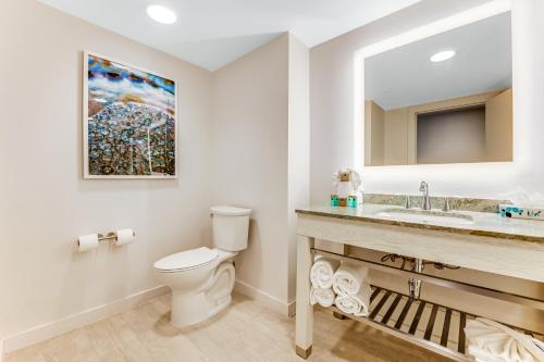 a bathroom with a toilet and a sink at Daytona Grande Oceanfront Resort in Daytona Beach