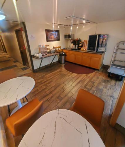 a room with two tables and chairs and a counter at Wyo Inn in Sheridan