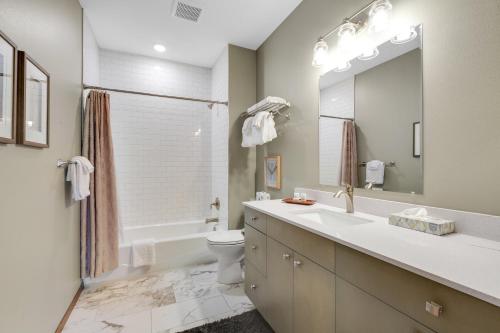 a bathroom with a sink and a toilet and a tub at Tumwater Vista Retreat, Unit 903 in Leavenworth