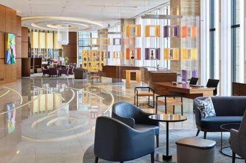 a lobby with chairs and tables in a building at InterContinental Hotel Osaka by IHG in Osaka