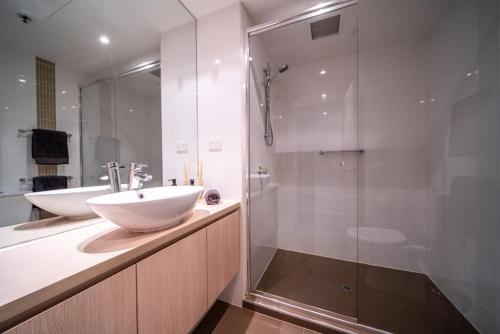 a bathroom with a white sink and a shower at Bliss at Balfours Adelaide in Adelaide