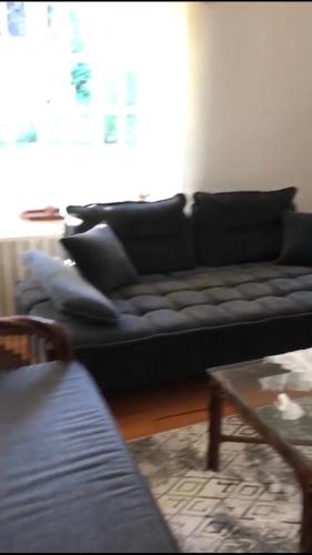 a living room with a black couch and a table at Villa by Lake Sapanca in Sapanca