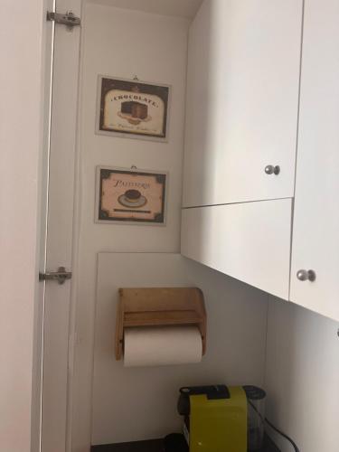 a bathroom with a toilet paper dispenser and a cabinet at PARIOLI LUXURY SUITe II in Rome