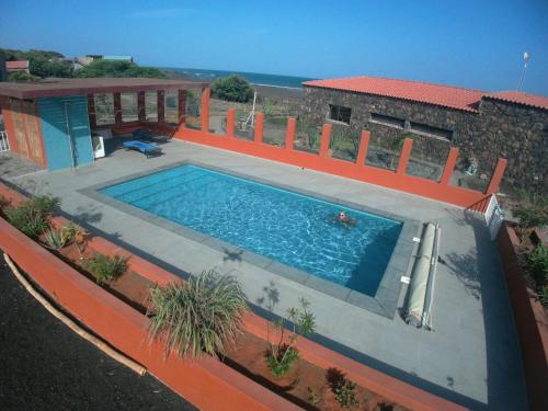 a swimming pool in front of a house at Vila Babosa in Porto Novo