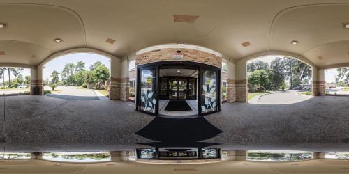 an empty building with three arched windows and a revolving door at MainStay Suites Savannah Midtown in Savannah