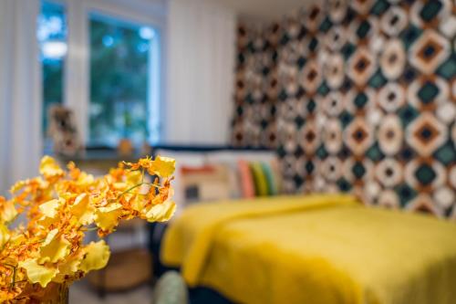 a yellow room with a bed and a yellow table at Harmony Boutique Hotel in Drawsko Pomorskie