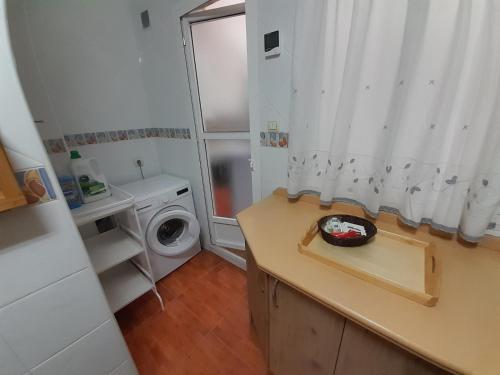 uma pequena casa de banho com uma máquina de lavar roupa e uma máquina de lavar roupa em CALZADA Homes em Almeria