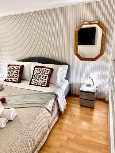 a bedroom with a bed with a mirror and a television at PARIOLI LUXURY SUITe II in Rome