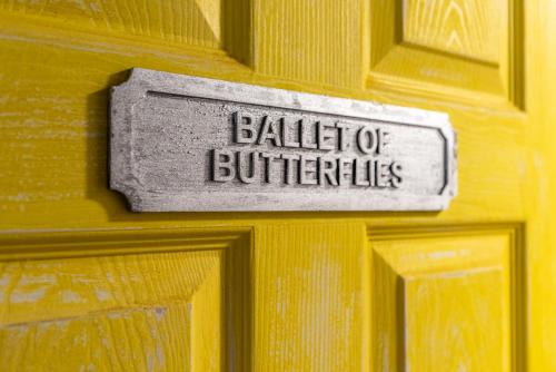 a sign on a wooden door with the words ballitt of butlerles at Baila Casa in Nottingham