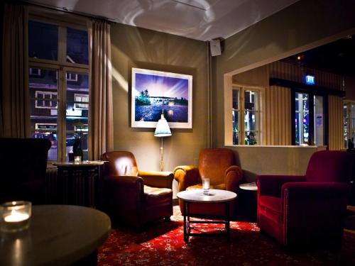 a living room with chairs and a table and a couch at Hotel Åregården in Åre