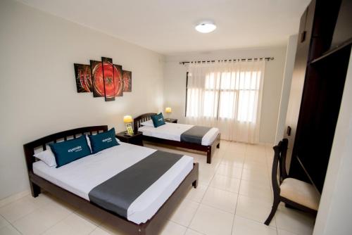 A bed or beds in a room at Hotel Casa Real Piura