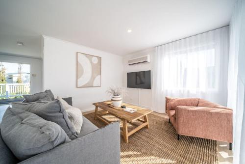 a living room with a couch and a table at Casa Del Sol Aldinga Beach in Aldinga Beach