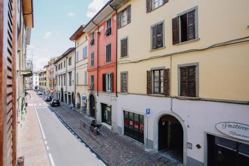 an empty street in a city with buildings at Flat Mazzini 6 in Alzano Lombardo