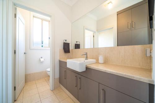 a bathroom with a sink and a toilet at The Arlington West Hindmarsh in Bowden