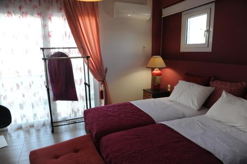 a bedroom with a large bed and a window at El Angel by Ntinos in Kremasti