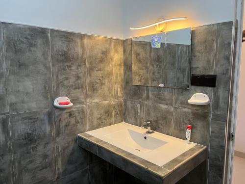 a bathroom with a sink and a mirror at Awesome Guest Mirissa in Mirissa