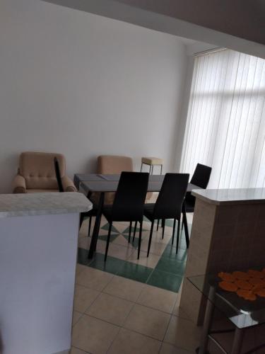 a dining room with a table and chairs at APARTMANI IGERČIĆ in Stinica
