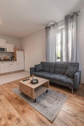 a living room with a couch and a coffee table at Apartments Florian in Lopud Island