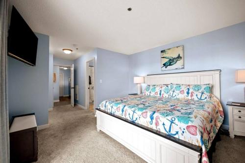 a bedroom with a bed and a television in it at Oceanview Resort*Hot tub*North Topsail Beach in North Topsail Beach