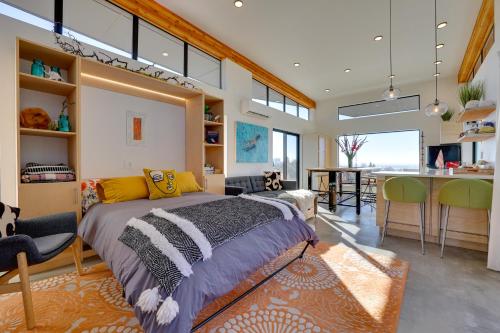 a bedroom with a bed and a dining room at Luxe, Modern Studio with Sweeping City Views! in Boise