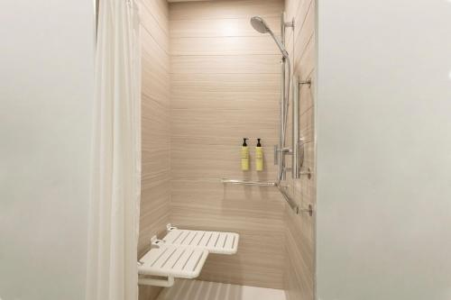a bathroom with a shower with a bench in it at Element Colorado Springs Downtown in Colorado Springs