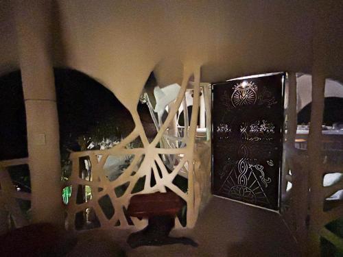 a room with a wall with a door and a chair at Ikalar in Akumal