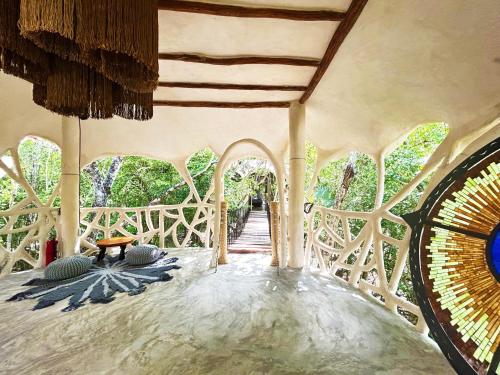 a room with a bridge with a table and chairs at Ikalar in Akumal