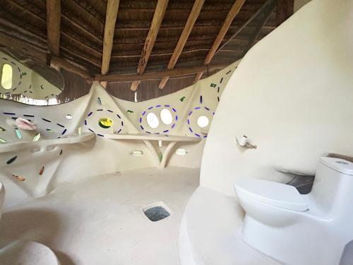 a bathroom with a toilet and a sink at Ikalar in Akumal