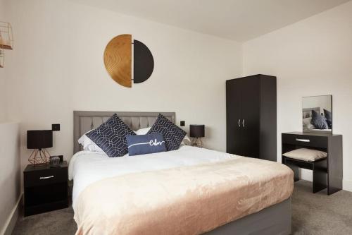 a bedroom with a large bed with black cabinets at Pottergate Views in Norwich