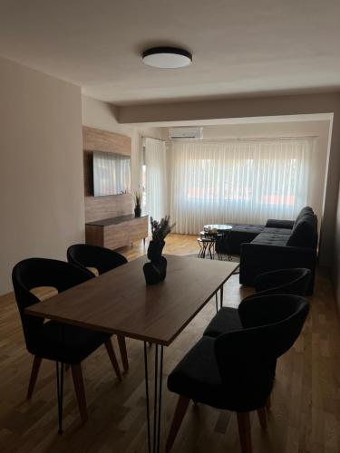 a living room with a table and chairs at Apartment33 in Strumica