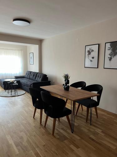 a living room with a couch and a table and chairs at Apartment33 in Strumica